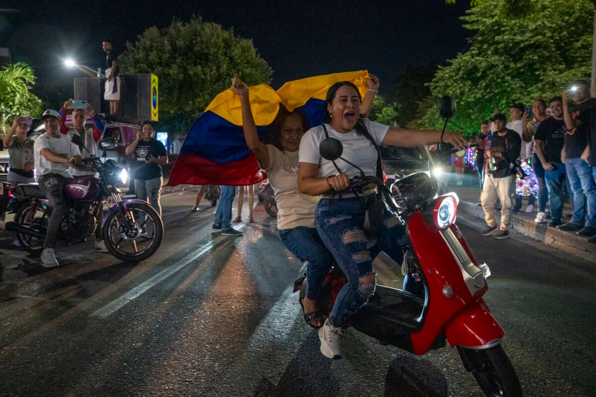 A Venezuelan motorcycle rider holds a flag along a highway on the Colombia–Venezuela border after the confirmation of Nicolás Maduro's capture in Caracas, Venezuela, in Cúcuta, Colombia, on Jan. 3, 2026. (Jair F. Coll/Getty Images)