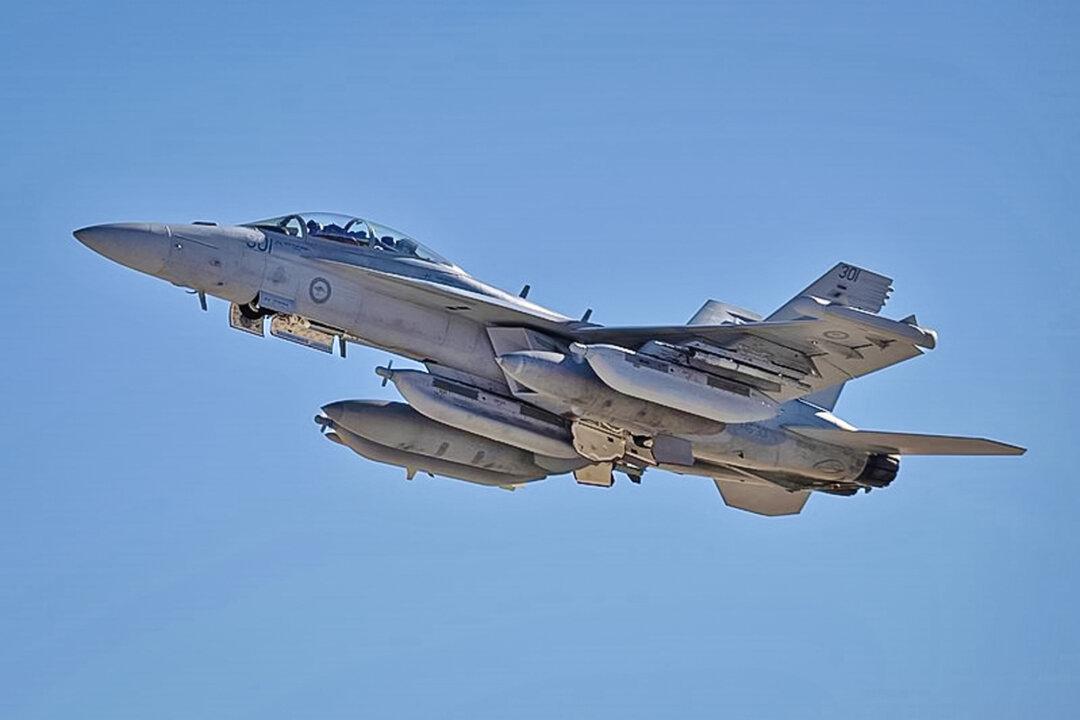 (Top Left) A B-1B Lancer flies over the Pacific Ocean during a Bomber Task Force mission on June 20, 2022. (Top Right) Royal Australian Air Force (RAAF) F-35A Lightning IIs receive fuel from a RAAF KC-30A Multi-Role Tanker Transport over Australia during Talisman Sabre 23 on July 23, 2023. (Bottom Left) An RAAF EA-18G Growler takes off from Amberley, Australia, for a mission during Red Flag 23-1 at Nellis Air Force Base, Nev., on Jan. 24, 2023. (Bottom Right) An E-2C Hawkeye assigned to the Greyhawks of Carrier Airborne Early Warning Squadron (VAW) 120 flies over Jacksonville, Fla., in this file image. (Master Sgt. Nicholas Priest/U.S. Air Force; Tech. Sgt. Eric Summers Jr./CC-PD-Mark; William R. Lewis/U.S. Air Force/Public Domain; Lt. j.g. John A. Ivancic/U.S. Navy)
