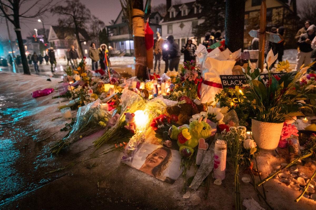 People gather at a memorial site made for Renee Nicole Good after she was shot and killed during an Immigration and Customs Enforcement (ICE) operation in Minneapolis on Jan. 8, 2026. (John Fredricks/The Epoch Times)