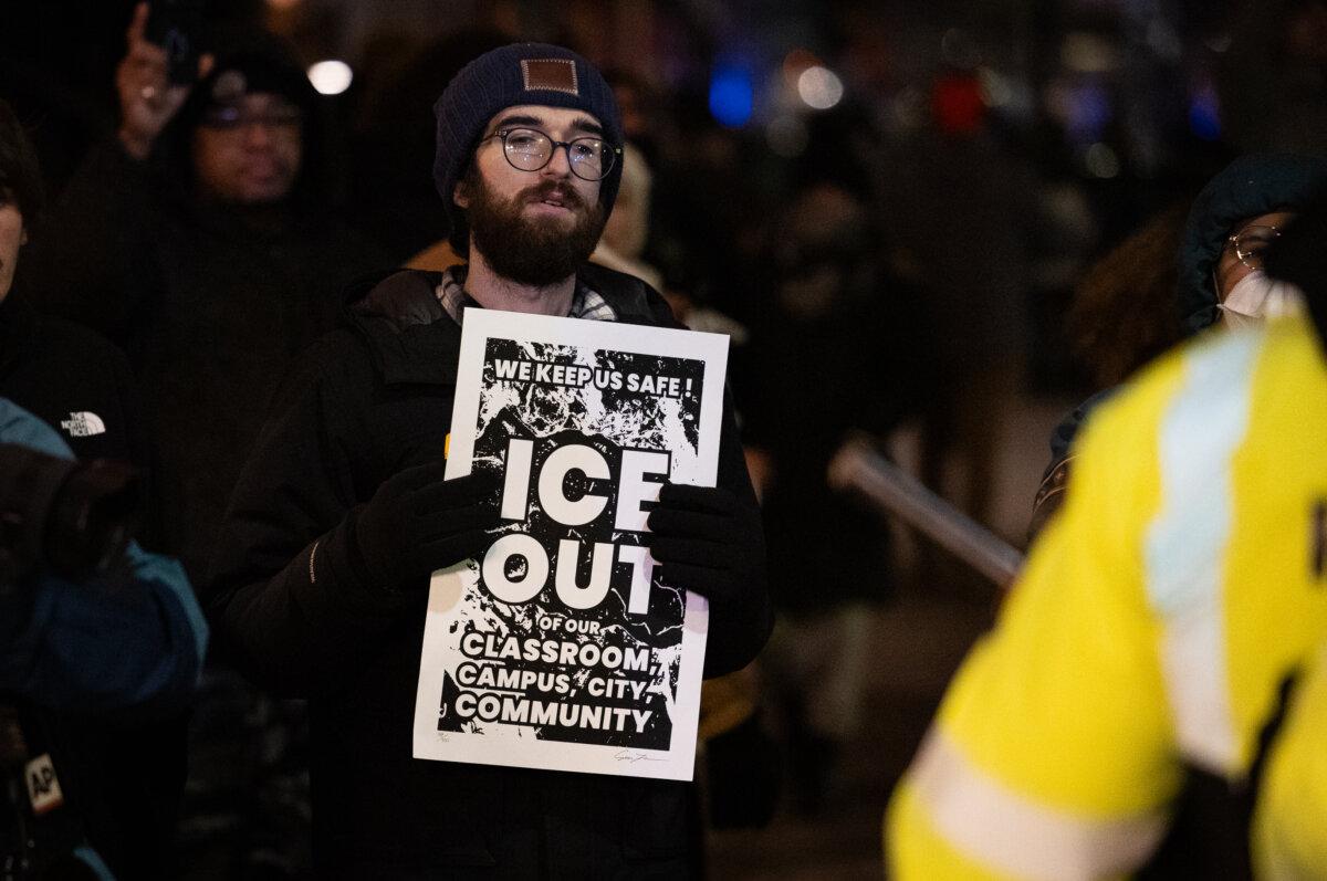 Protestors against Immigration and Customs Enforcement operations face off with police officers in Minneapolis on Jan. 9, 2026. (John Fredricks/The Epoch Times)