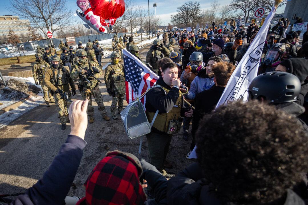 Protesters face off with federal officers outside the Bishop Henry Whipple Federal Building in Minneapolis on Jan. 9, 2026. Demonstrations erupted after Renée Good was fatally shot by an ICE agent during an operation earlier that week. (John Fredricks/The Epoch Times)