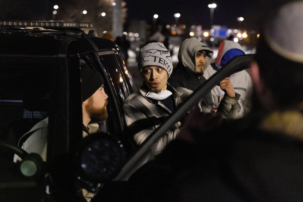 Protestors file a police report against YouTuber Nick Sorter in front of the Bishop Henry Whipple Federal Building in Minneapolis on Jan. 11, 2026. (John Fredricks/The Epoch Times)