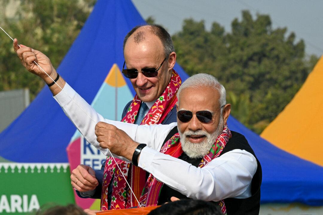 India's Prime Minister Narendra Modi flies a kite alongside German Chancellor Friedrich Merz during the International Kite Festival in Ahmedabad, India, on Jan. 12, 2026. (Shammi Mehra/AFP via Getty Images)