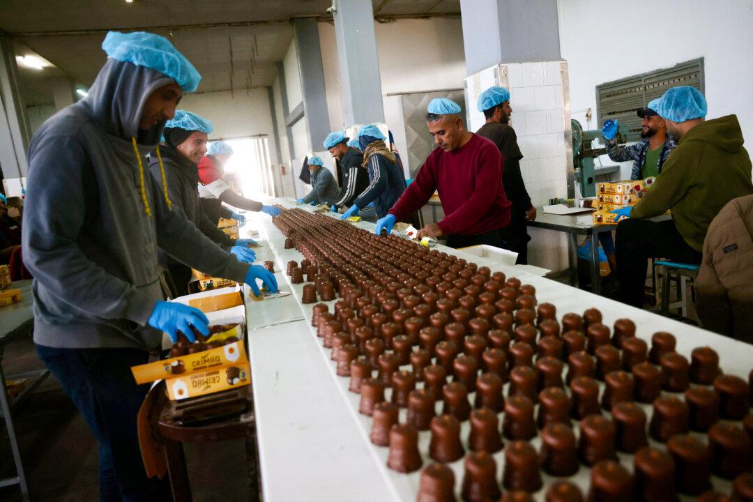 Palestinian workers box sweets locally known as “al-Shatwi” (Winter) Crimbo sweets on Jan. 12, 2026. The Al-Arees factory is gradually resuming operation after a hiatus caused by the Gaza war, which led to shortages of raw materials used in their products, in Deir al-Balah, in the central Gaza Strip, after a U.S.-brokered truce halted the two-year war. (Bashar Taleb/AFP via Getty Images)