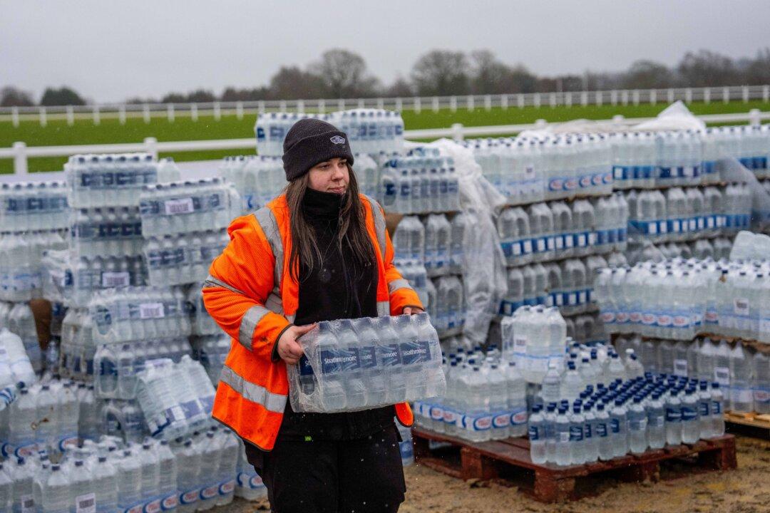 Bottled water is loaded into a car at an emergency water distribution point in Tunbridge Wells, England, on Jan. 13, 2026. Kent County Council has declared a major incident as an estimated 30,000 properties across Kent and Sussex have been impacted by water supply issues over recent days, forcing schools and businesses to close. South East Water said Storm Goretti affected the water company's ability to treat raw water, coupled with burst water mains attributed to freezing and thawing conditions. (Carl Court/Getty Images)