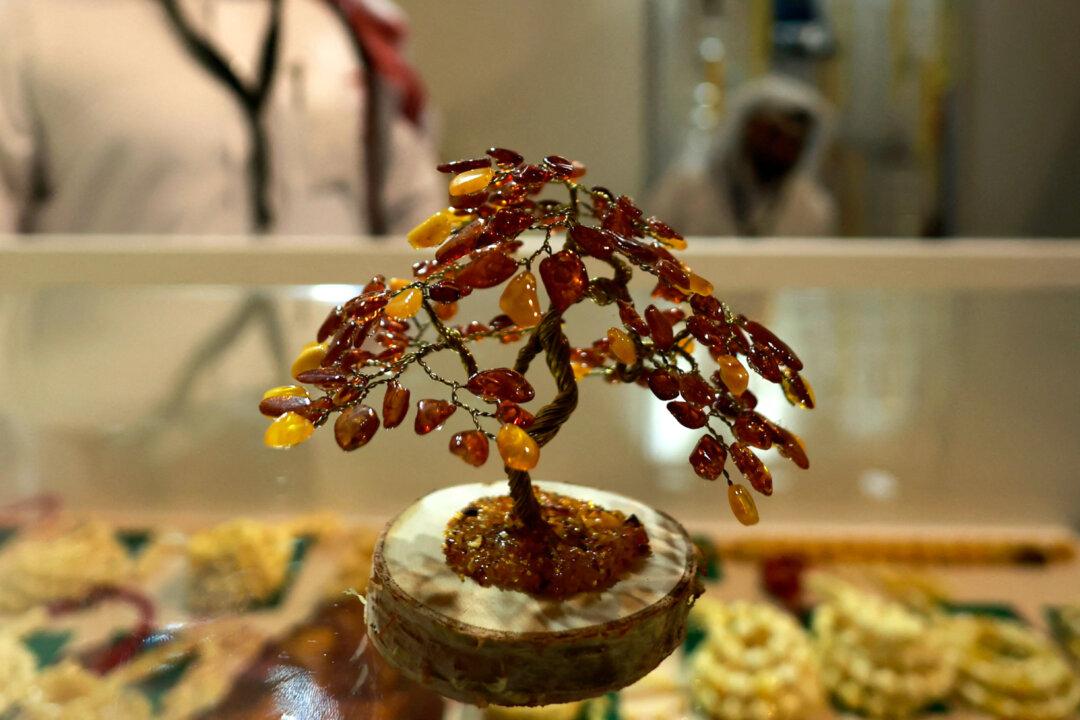 A tree decoration made of amber is displayed at the Katara International Exhibition for Kahraman, showcasing amber artwork and handicrafts at the Katara cultural village in Doha, Qatar, on Jan. 13, 2026. (Karim Jaafar/AFP via Getty Images)