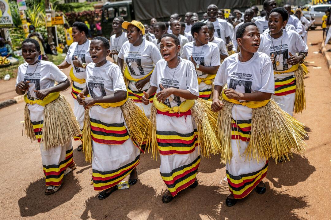 Traditional Ugandan dancers perform as supporters of Uganda's incumbent president and National Resistance Movement (NRM) presidential candidate Yoweri Museveni enter the rally grounds before the party's closing campaign event ahead of the 2026 Ugandan general elections, in Kampala, on Jan. 13, 2026. (AFP via Getty Images)