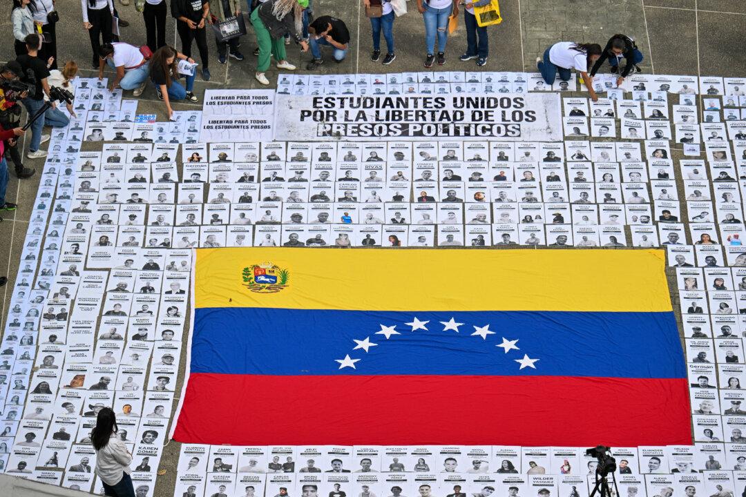 Relatives display portraits of political prisoners during a demonstration at the Central University of Venezuela in Caracas, on Jan. 13, 2026. Venezuela said on Jan. 12, it had freed dozens more political prisoners as rights groups questioned the numbers and family members clamored for speedier releases after the U.S. military ouster of long-term autocrat Nicolás Maduro. (Juan Barreto/AFP via Getty Images)