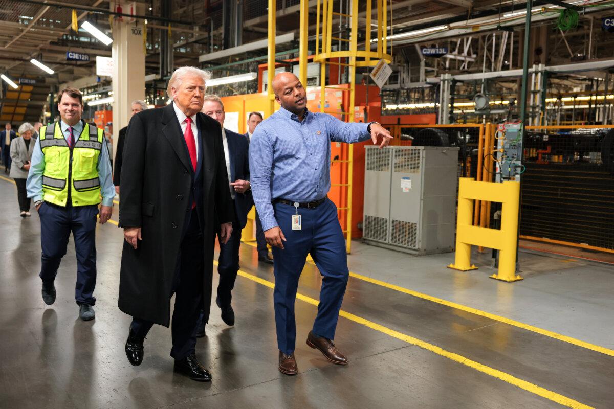 U.S. President Donald Trump walks with Ford River Rouge Plant Manager Corey Williams (R) as they tour the Ford River Rouge Complex, in Dearborn, Mich., on Jan. 13, 2026. (Anna Moneymaker/Getty Images)