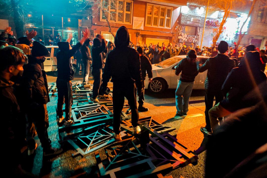 (Top Left) Iranians block a street, and vehicles are set on fire during a protest in Tehran, Iran, on Jan. 8–9, 2026. (Top Center) A vehicle burns during protests in Tehran, Iran, on Jan. 8, 2026. (Top Right) Iranians gather while blocking a street during a protest in Tehran, Iran, on Jan. 9, 2026. (Bottom Left) People gather during a protest in Tehran, Iran, on Jan. 8, 2026. (Bottom Center) People gather during a protest in Tehran, Iran, on Jan. 8, 2026. (Bottom Right) A dumpster burns during unrest in Tehran, Iran, on Jan. 8, 2026. (MAHSA/Middle East Images/AFP via Getty Images, Khoshiran/Middle East Images/AFP via Getty Images, Anonymous/Getty Images)