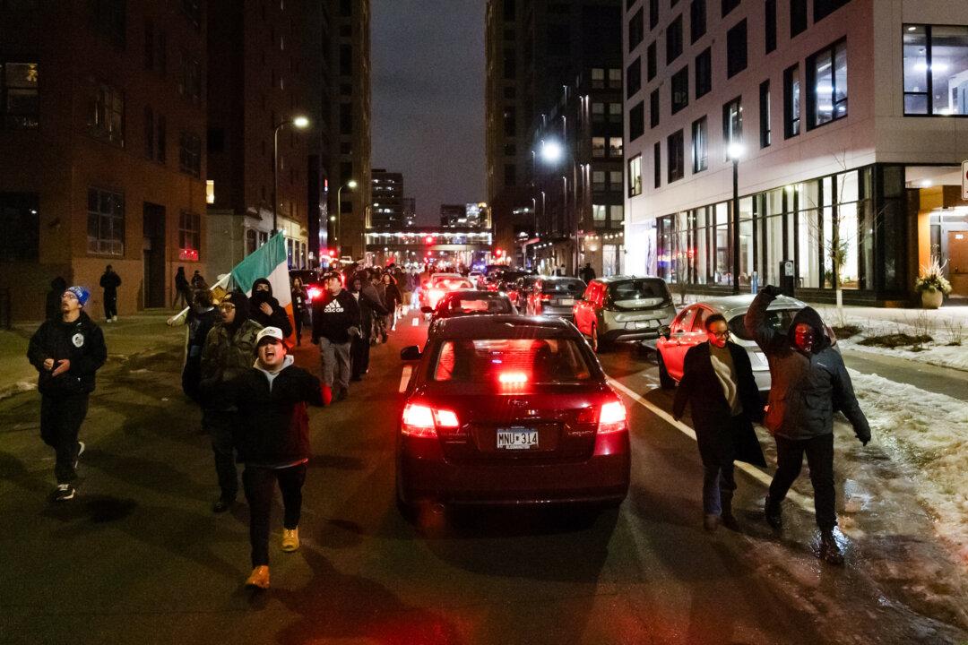 (Top Left) Protesters demonstrate in front of the Bishop Henry Whipple Federal Building in Minneapolis on Jan. 9, 2026. (Top Middle) Federal officers detain a women in front of the Bishop Henry Whipple Federal Building in Minneapolis on Jan. 9, 2026. (Top Right) Protesters demonstrate in front of federal officers and the Bishop Henry Whipple Federal Building in Minneapolis on Jan. 9, 2026. (Bottom Left) Protesters demonstrate in front of federal officers and the Bishop Henry Whipple Federal Building in Minneapolis on Jan. 11, 2026. (Bottom Middle) A protester talks to a sheriff’s deputy (L) in front of the Bishop Henry Whipple Federal Building in Minneapolis on Jan. 11, 2026. (Bottom Right) People protest against federal immigration operations in Minneapolis on Jan 9., 2026. (John Fredricks/The Epoch Times)