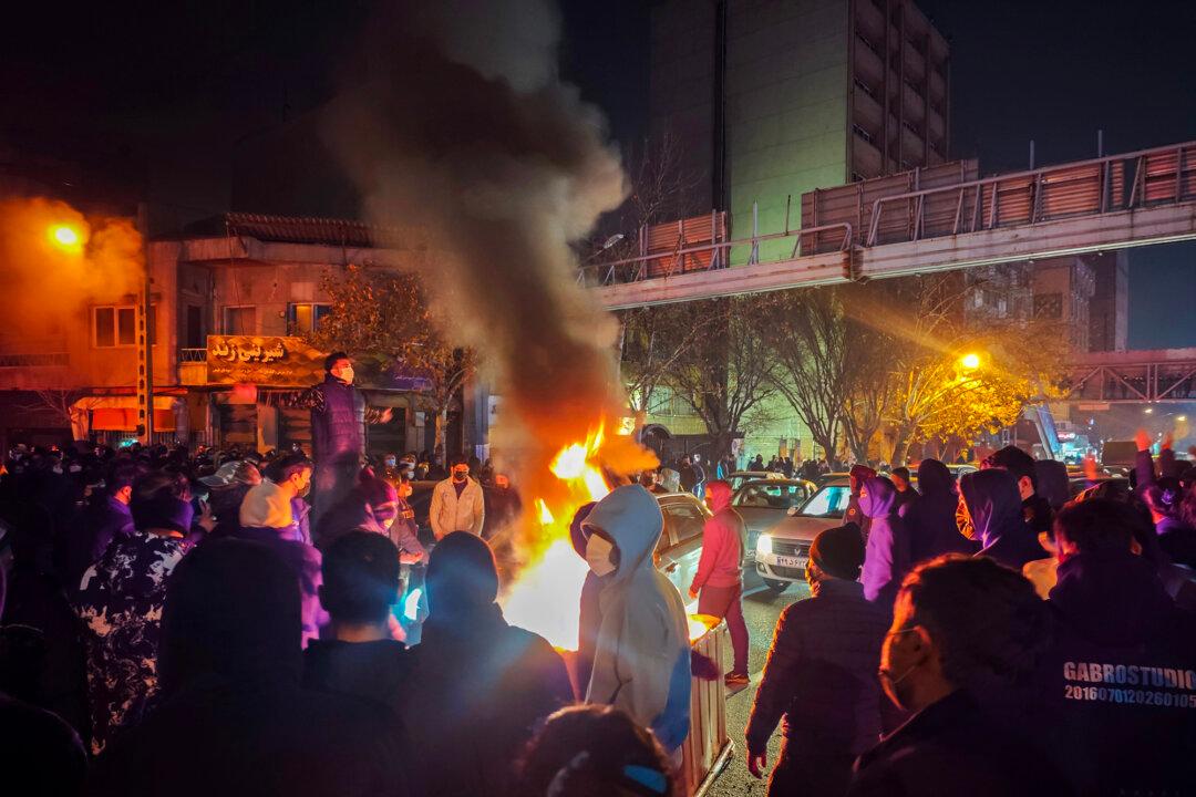 Iranians gather while blocking a street during a protest in Tehran, Iran, on Jan. 9, 2026. The nationwide protests started in Tehran’s Grand Bazaar against the failing economic policies in late December 2025, and spread to universities and other cities, and broadened to wider discontent about the regime. (Khoshiran/Middle East Images/AFP via Getty Images)