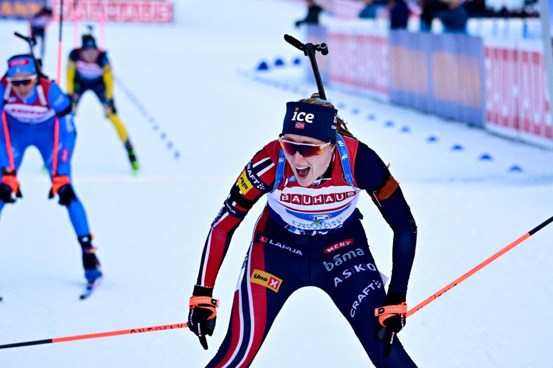 Norway's Maren Kirkeeide celebrates as she crosses the finish line during the women's 4x6km relay event of the IBU Biathlon World Cup in Ruhpolding, Germany, on Jan. 14, 2026. (Tobias Schwarz/AFP via Getty Images)