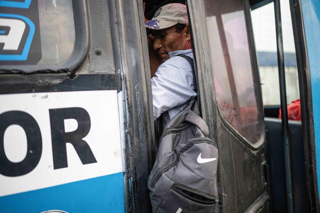 A man is inside a crowded bus during a strike called by public transport companies against extortion and to demand greater security in Lima, Peru, on Jan. 14, 2026. (Ernesto Benavides/AFP via Getty Images)