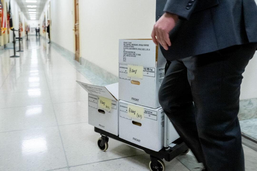 Staff wheel boxes marked “Hillary” into a room ahead of a scheduled closed-door deposition by the House Oversight Committee of former U.S. Secretary of State Hillary Clinton on Capitol Hill in Washington on Jan. 14, 2026. Clinton did not appear. (Saul Loeb/AFP via Getty Images)