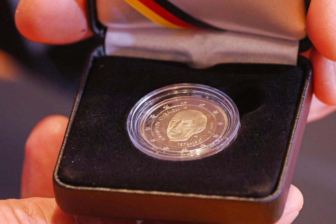 A member of the government cabinet holds up the new two-Euro coin that shows former Chancellor of Germany Konrad Adenauer at the weekly federal government cabinet meeting in Berlin, Germany, on Jan. 14, 2026. (Sean Gallup/Getty Images)