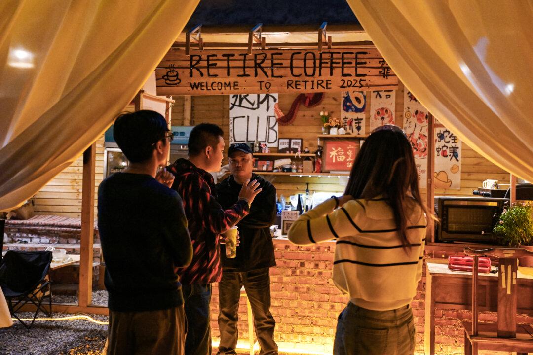 Young Chinese people chat after watching a musician perform at a “youth retirement home” in Dali, Yunnan Province, China, on April 2, 2025. “Youth retirement homes” have appeared as young Chinese adopt a “lying flat” lifestyle and reject the intense work culture once common in China. (Greg Baker/AFP via Getty Images)