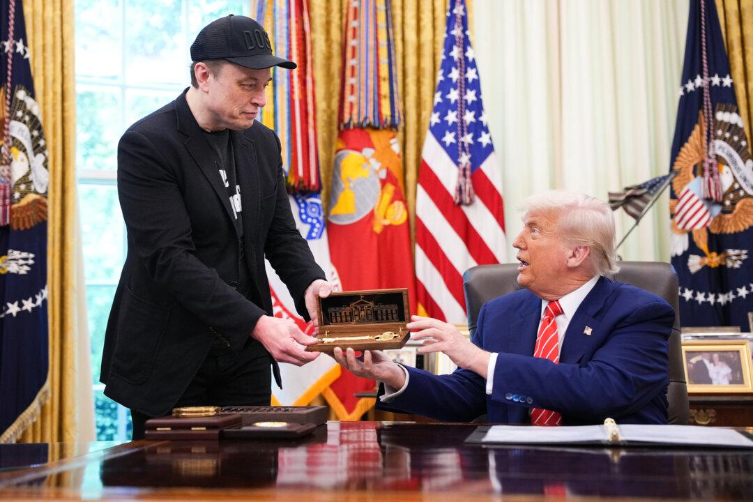 Tesla CEO Elon Musk receives a key from President Donald Trump in the Oval Office on May 30, 2025. Musk served as an adviser to Trump and led the Department of Government Efficiency. (Kevin Dietsch/Getty Images)