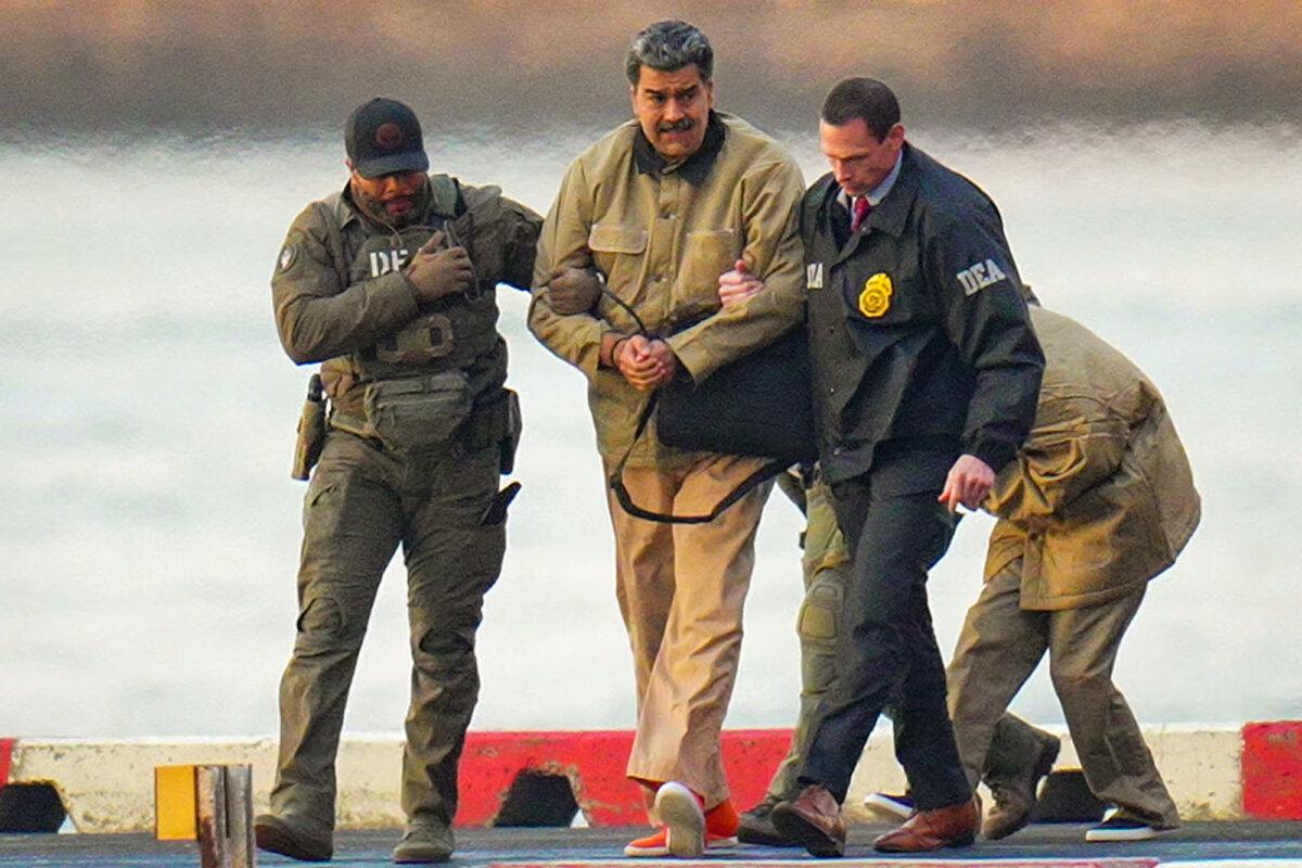 Nicolás Maduro and his wife, Cilia Flores (rear), are escorted by federal agents after landing at a Manhattan helipad, as they make their way into an armored car en route to a federal courthouse in New York City on Jan. 5, 2026. (XNY/Star Max/GC Images)