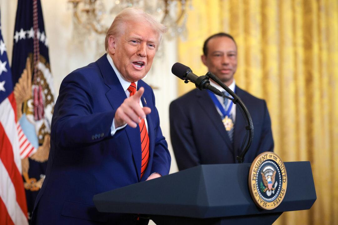 President Donald Trump, joined by golf legend Tiger Woods, speaks during a reception honoring Black History Month in the East Room of the White House on Feb. 20, 2025. The Black History Month celebration came as Trump had signed a series of executive orders ending federal diversity, equity, and inclusion programs and cutting funding to schools and universities that do not cut such programs. (Win McNamee/Getty Images)