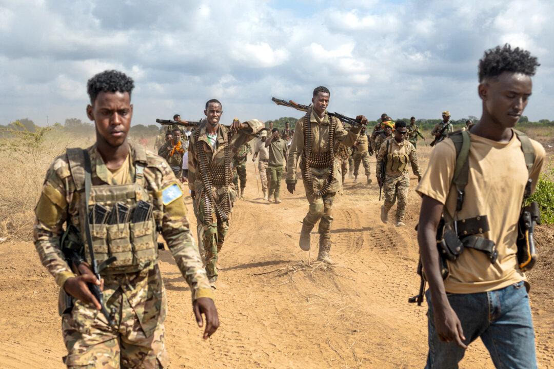 Soldiers of the Somali National Army walk near the frontlines at Sabiid, one of the towns that the army has liberated from Al-Qaeda-linked terrorists Al-Shabaab, in Somalia's lower-Shabelle region on Nov. 11, 2025. (Tony Karumba/AFP via Getty Images)