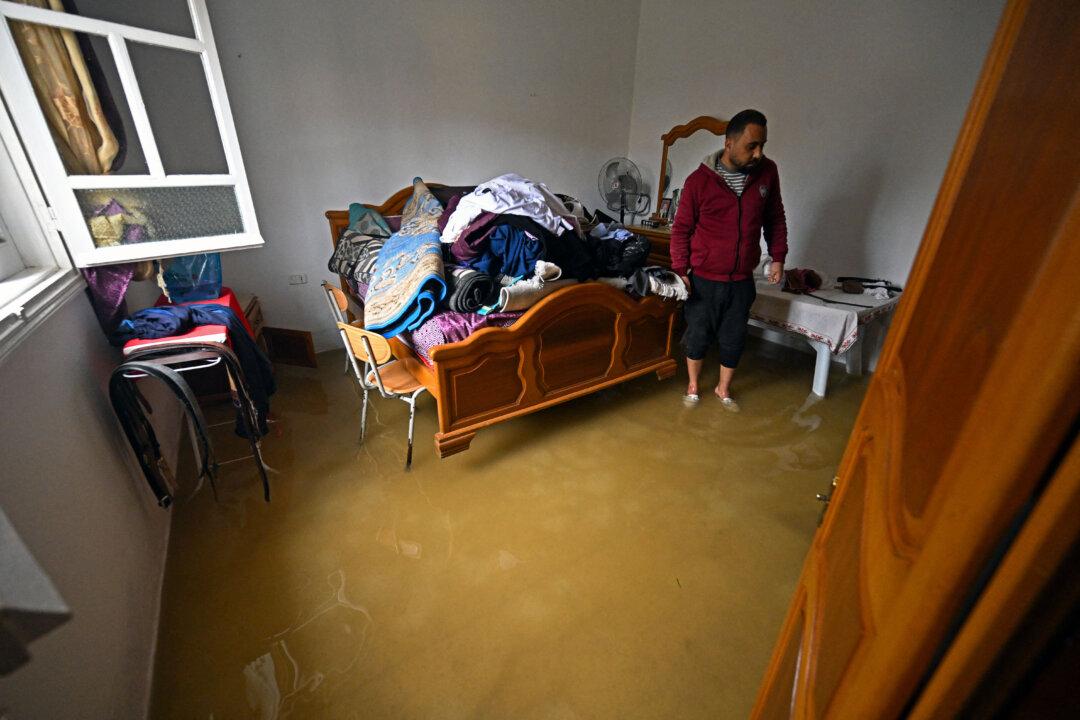 A resident stands inside his flooded house after heavy rain in the Raoued neighborhood of Ariana district near Tunis, Tunisia, on Jan. 21, 2026. Flooding has killed four people, authorities said on Jan. 20, as schools and businesses were forced to close after parts of the country experienced their heaviest rainfall in more than 70 years. (Fethi Belaid/AFP via Getty Images)
