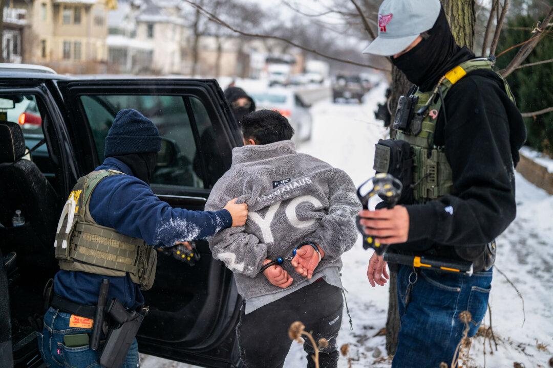 A man is detained by a Border Patrol agent in Minneapolis on Jan. 21, 2026. The Trump administration has sent a reported 3,000 federal agents into the area, with more on the way, as they make a push to arrest undocumented immigrants in the region. (Stephen Maturen/Getty Images)