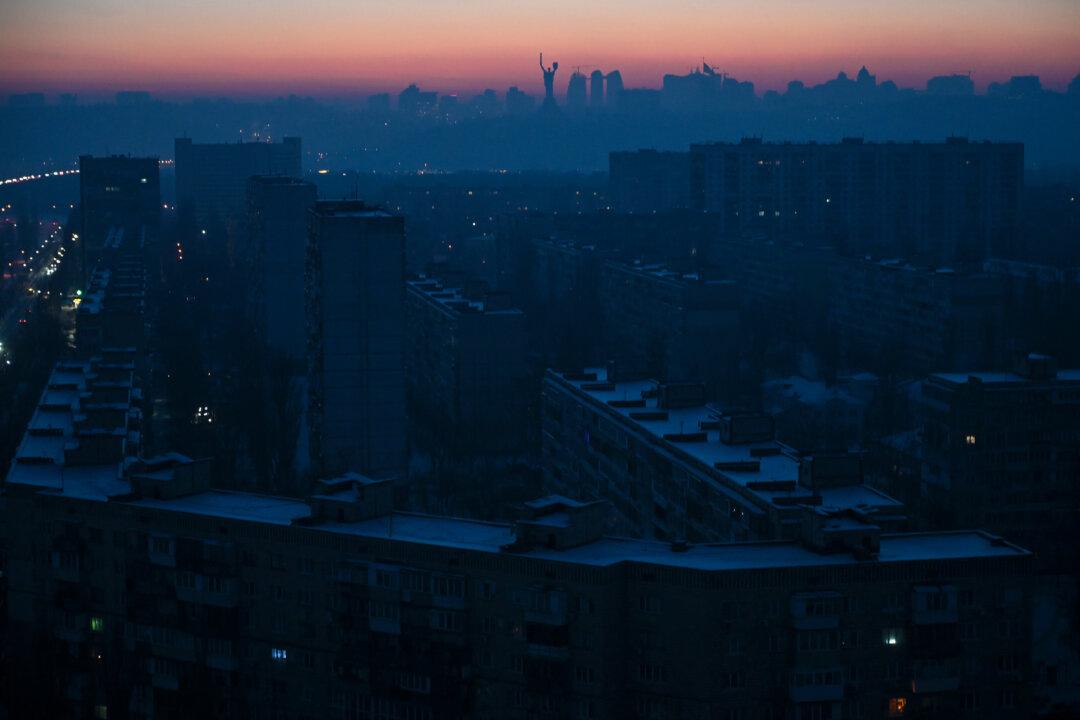 Residential buildings with the Motherland Monument in the background are seen during a power outage in Kyiv on Jan. 21, 2026, amid the Russian invasion of Ukraine. (Eugene Kotenko/AFP via Getty Images)