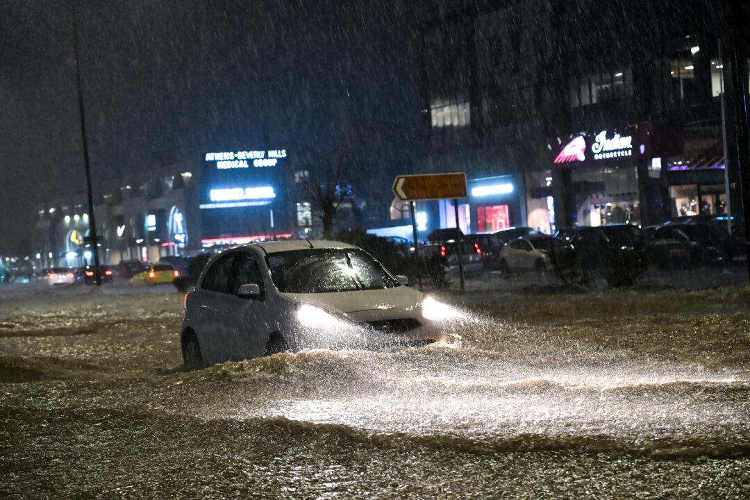 Heavy rainfall on Vouliagmenis Avenue in the southern suburbs of Athens, Greece, on Jan. 21, 2026. (SOOC/AFP via Getty Images)