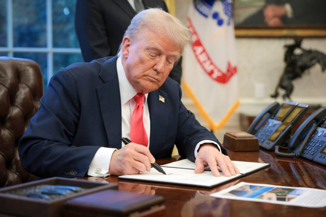 President Donald Trump signs an executive order in the Oval Office on Feb. 25, 2025. Trump’s order, titled “Ending Taxpayer Subsidization of Open Borders,” seeks to prevent taxpayer funds from being used in ways that encourage illegal immigration. (Alex Wong/Getty Images)