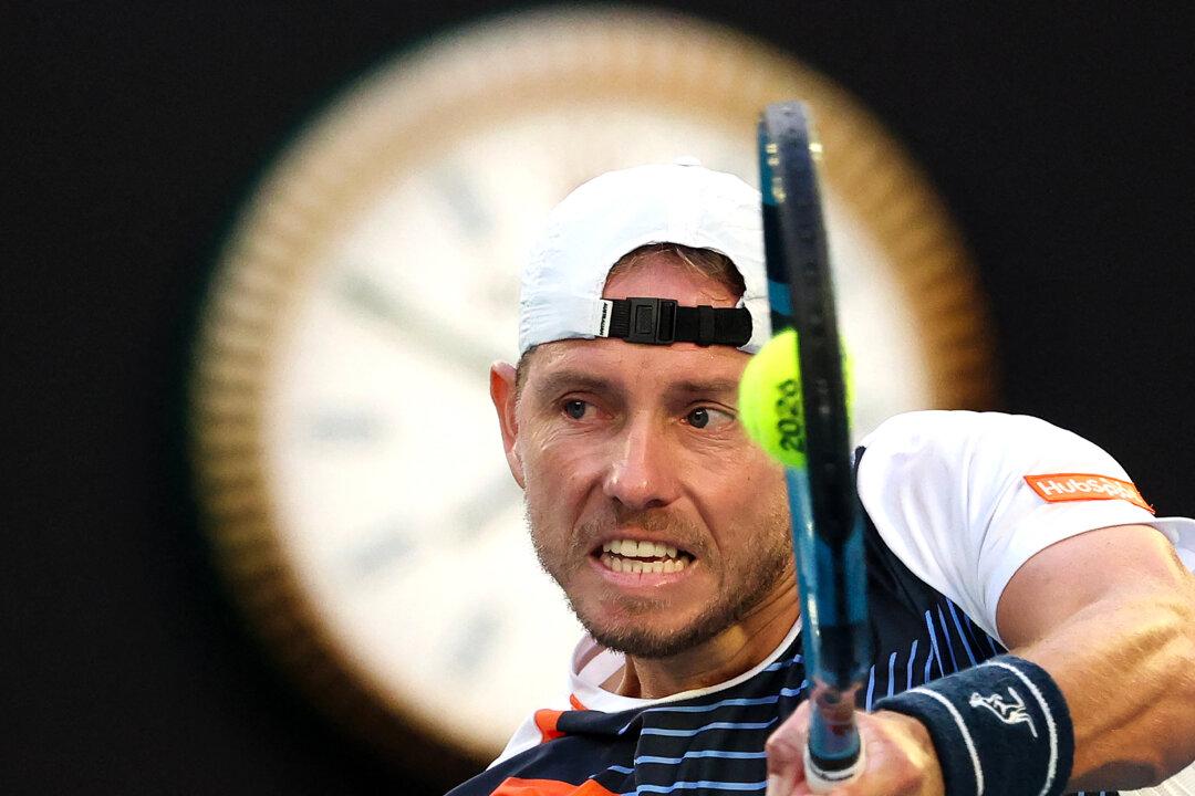 Australia's James Duckworth hits a return to Italy's Jannik Sinner during their men's singles match on day five of the Australian Open tennis tournament in Melbourne, Australia, on Jan. 22, 2026. (David Gray/AFP via Getty Images)