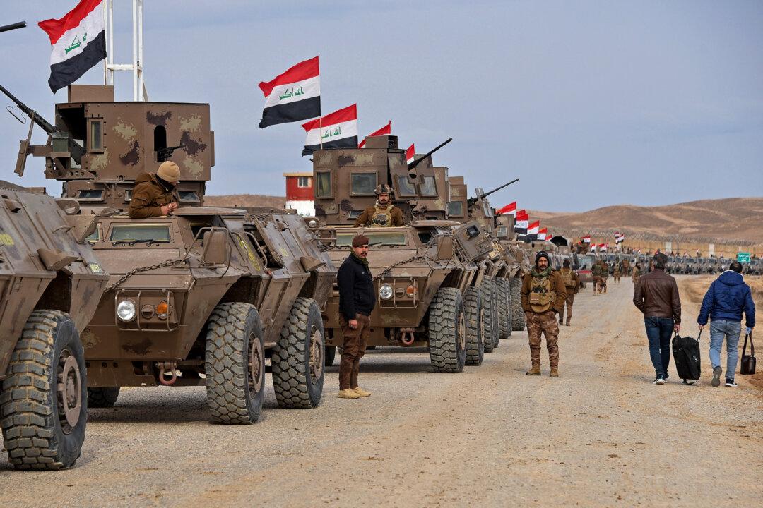 Iraqi border security personnel stand guard next to their armored vehicles along the border with Syria, in Sinjar district, northern Iraq, on Jan. 22, 2026, following recent tensions in Syria. (Zaid Al-Obeidi/AFP via Getty Images)