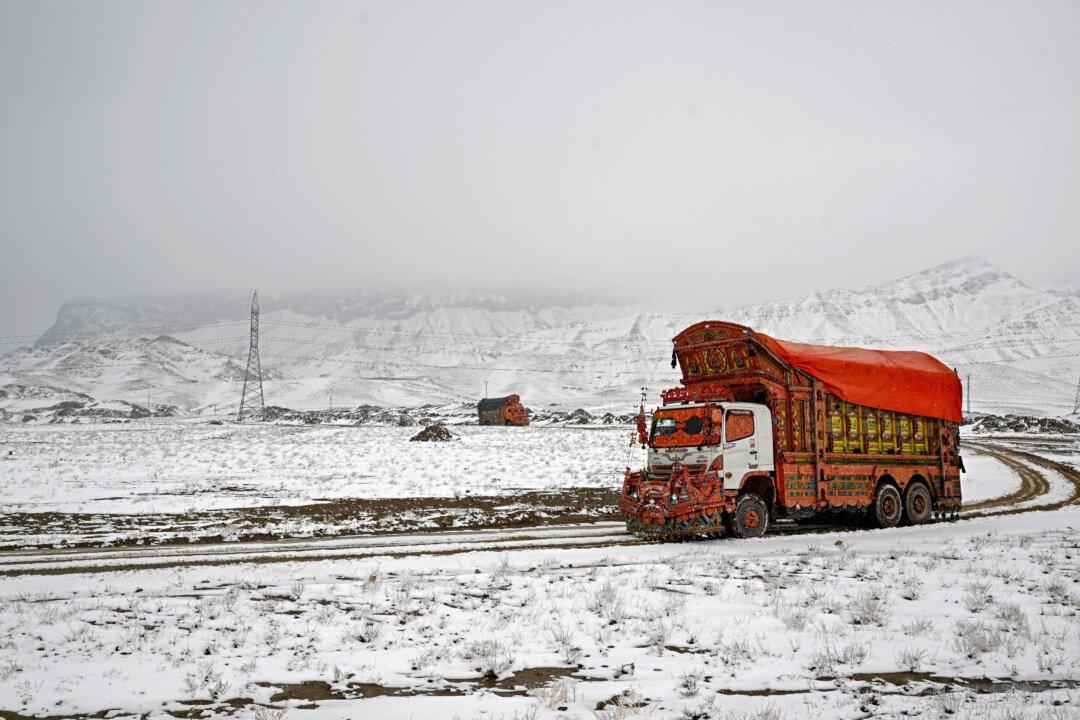 A truck drives on a snow-covered road at the outskirts of Quetta, Pakistan, on Jan. 22, 2026. (Banaras Khan/AFP via Getty Images)
