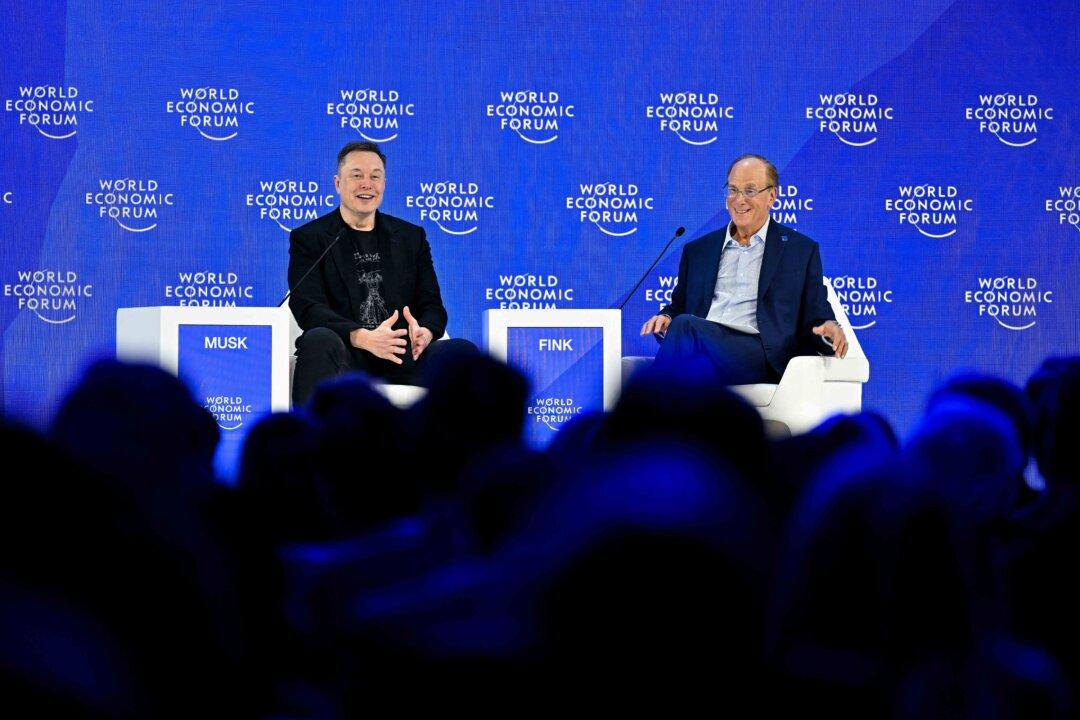 CEO of SpaceX and Tesla, businessman Elon Musk, speaks with BlackRock chairman and WEF co-chairman Larry Fink during the World Economic Forum annual meeting in Davos, Switzerland, on Jan. 22, 2026. (Fabrice Coffrini/AFP via Getty Images)