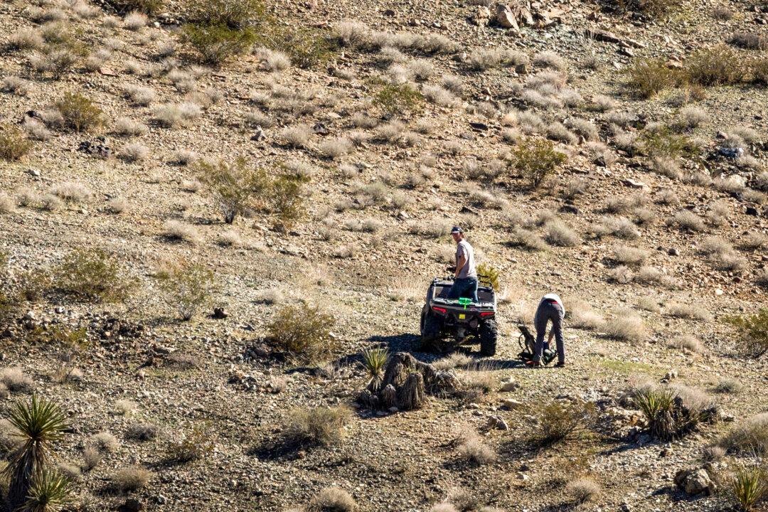 Men with portable mining equipment exit a preexisting mining claim area in San Bernardino County, Calif., on Dec. 10, 2025. (John Fredricks/The Epoch Times)