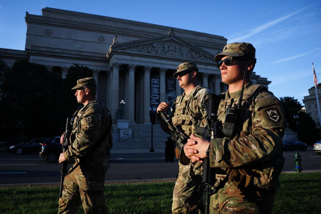 Members of the National Guard patrol Constitution Avenue in Washington, D.C, on Aug. 26, 2025. (Win McNamee/Getty Images)