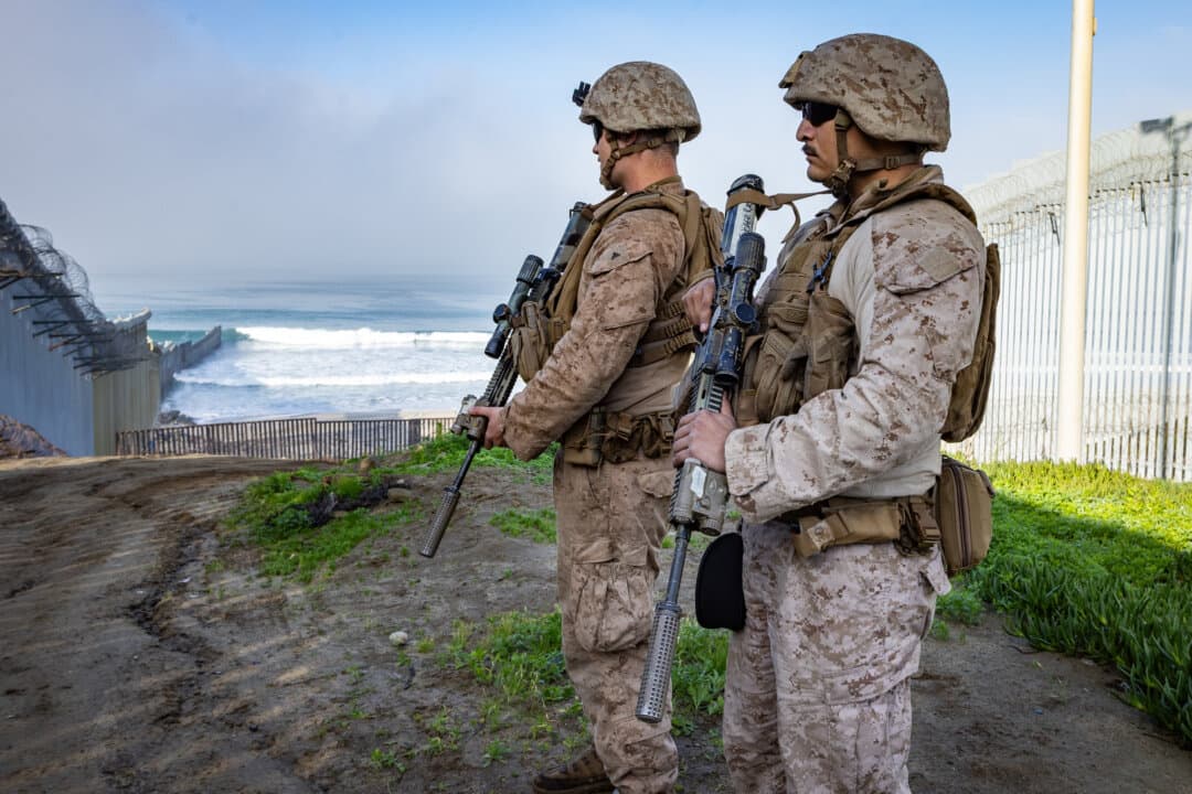 (Top) The Pacific terminus of the U.S. border wall is seen outside San Diego on Jan. 20, 2026. (Bottom Left) The U.S. border wall outside San Diego on Jan. 20, 2026. (Bottom Right) U.S. Marines patrol the U.S.–Mexico border near San Diego on Jan. 20, 2026. (John Fredricks/The Epoch Times)