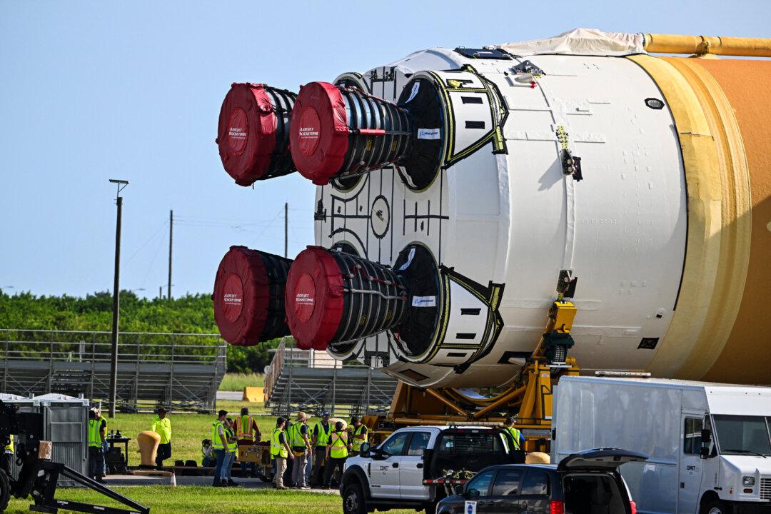 (Left) Artemis II sits in the Vehicle Assembly Building at Kennedy Space Center in Cape Canaveral, Fla., on Jan. 16, 2026. (Right) The Artemis II rocket core stage of NASA's Space Launch System is offloaded from the Pegasus Barge at Kennedy Space Center in Florida, on July 24, 2024. (Jim Watson/AFP via Getty Images, Chandan Khanna/AFP via Getty Images)