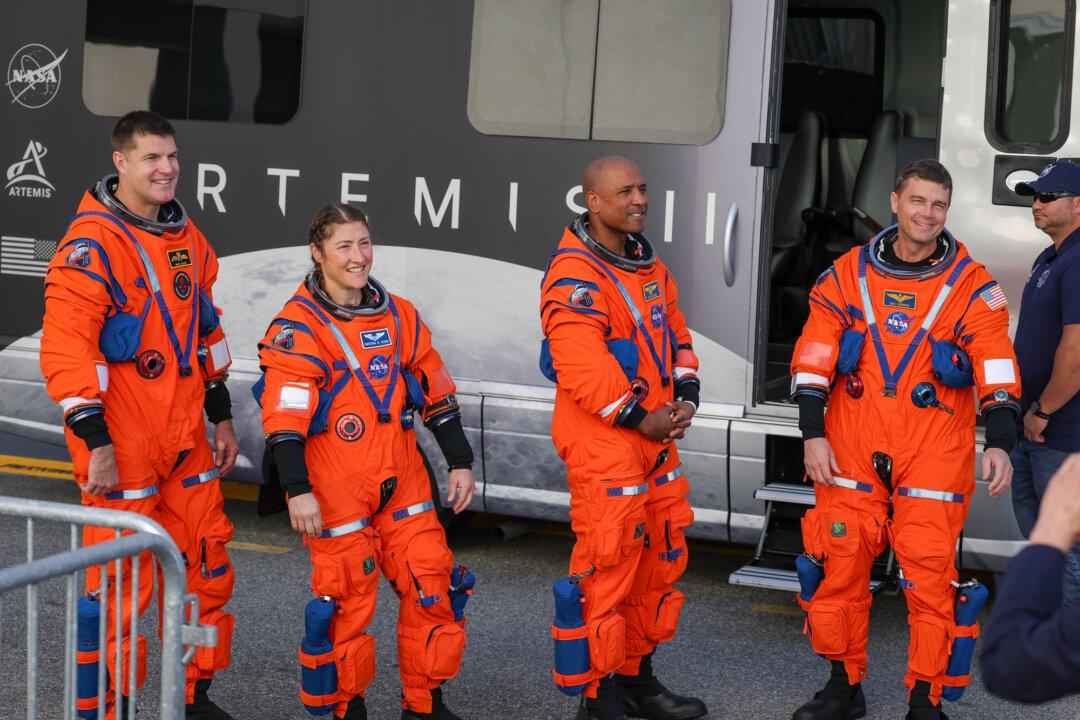 (L–R) The Artemis II crew—mission specialist Jeremy Hansen of the Canadian Space Agency, mission specialist Christina Koch, pilot Victor Glover, and commander Reid Wiseman—rehearse a walkout from the Neil A. Armstrong Operations and Checkout Building at NASA’s Kennedy Space Center in Cape Canaveral, Fla., on Dec. 20, 2025. The astronauts are rehearsing for the scheduled 10-day mission in February, which will take them around the moon and back to Earth. (Joe Raedle/Getty Images)