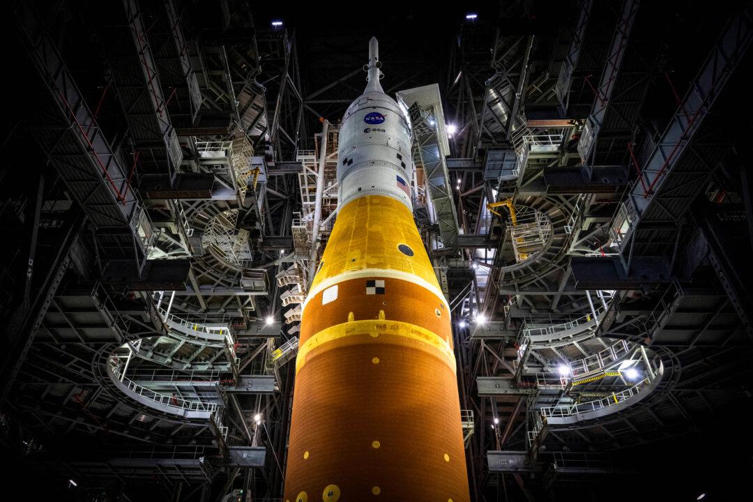 (Left) Artemis II sits in the Vehicle Assembly Building at Kennedy Space Center in Cape Canaveral, Fla., on Jan. 16, 2026. (Right) The Artemis II rocket core stage of NASA's Space Launch System is offloaded from the Pegasus Barge at Kennedy Space Center in Florida, on July 24, 2024. (Jim Watson/AFP via Getty Images, Chandan Khanna/AFP via Getty Images)
