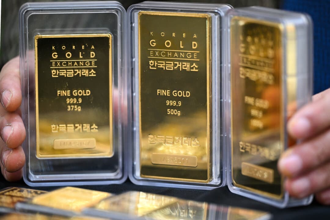 An employee displays gold bars at a store of the Korea Gold Exchange in Seoul, South Korea, on Jan. 26, 2026. The price of safe-haven asset gold surpassed $5,000 on Jan. 25, hitting a record high. (Jung Yeon-je / AFP via Getty Images)