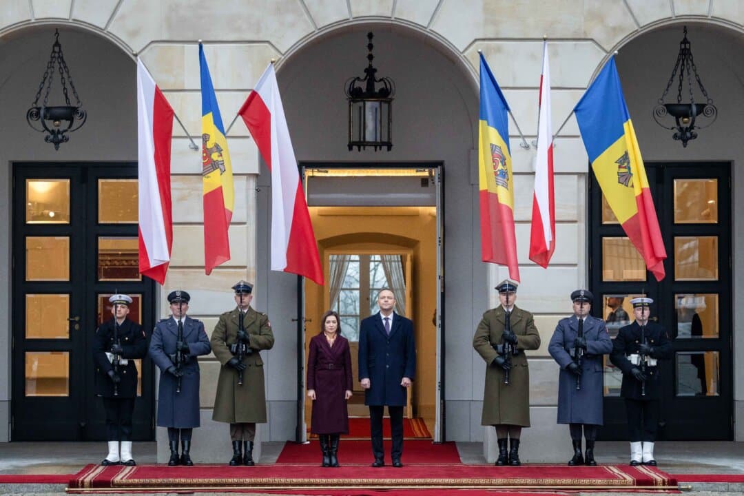 Poland's President Karol Nawrocki and Moldova's President Maia Sandu listen to the national anthems during an official welcoming ceremony at the Presidential Palace in Warsaw, Poland, on Jan. 26, 2026. (Wojtek Radwanski / AFP via Getty Images)