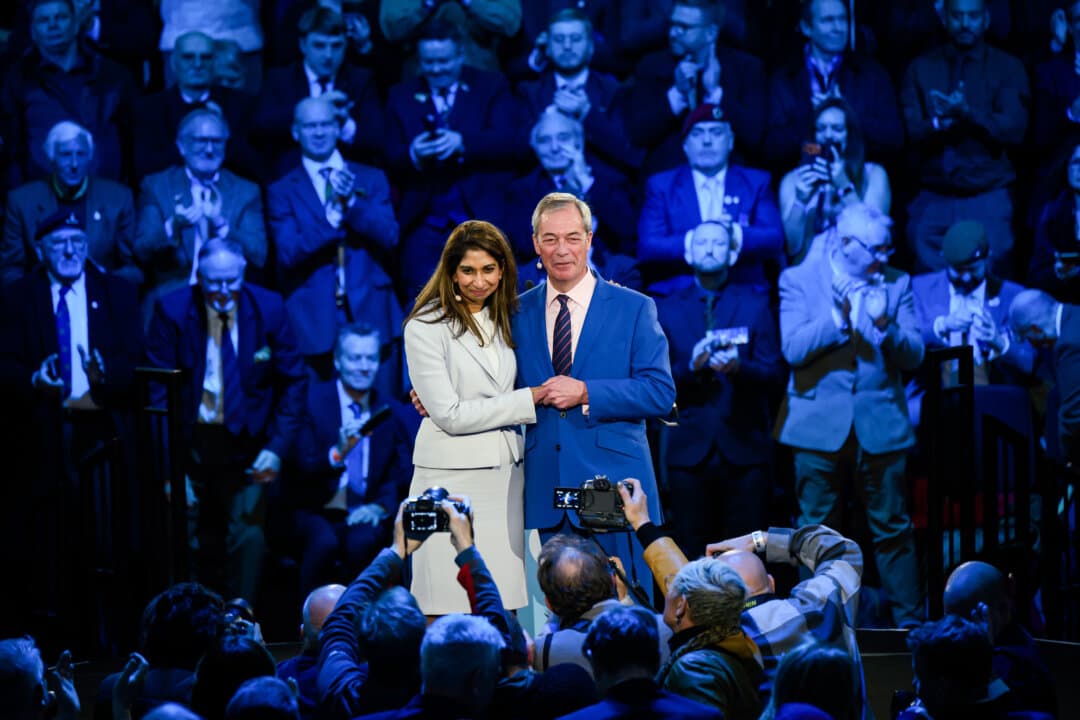 Reform UK leader Nigel Farage embraces former Conservative Home Secretary Suella Braverman, who has defected to Reform UK, during a press conference to launch ‘Veterans for Reform’ in London, England, on Jan. 26, 2026. (Leon Neal/Getty Images)
