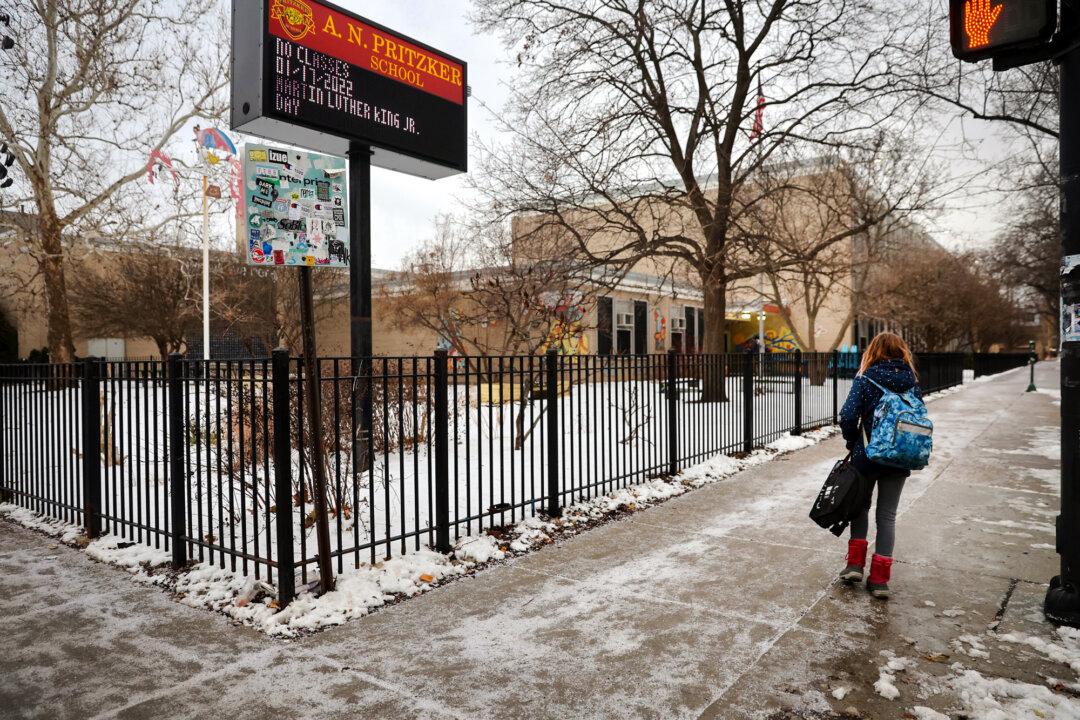 A student arrives for classes at A. N. Pritzker Elementary School in Chicago on Jan. 12, 2022. (Scott Olson/Getty Images)