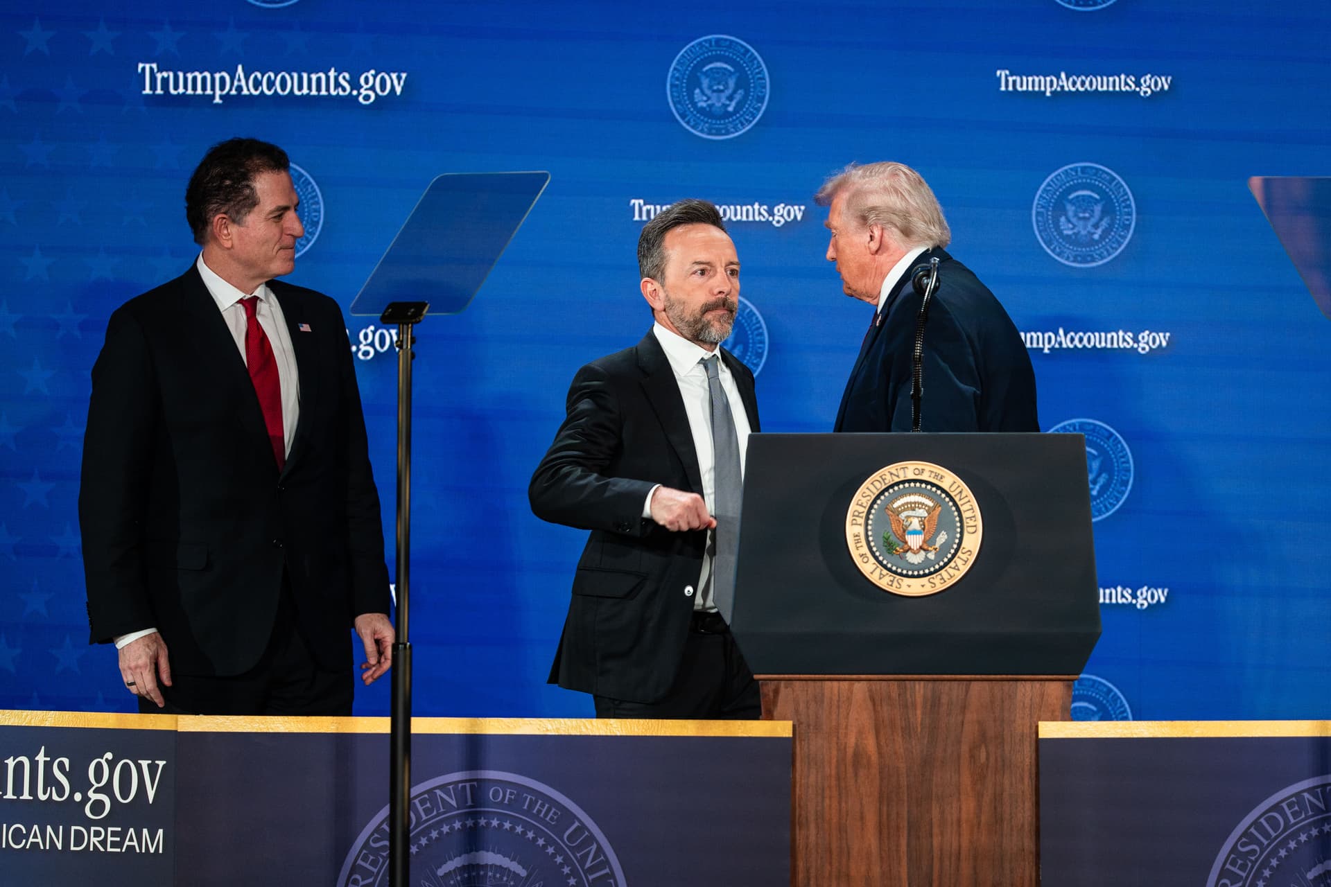 (L-R) Founder and CEO of Dell Technologies Michael Dell, founder and CEO of Altimeter Capital Brad Gerstner, and President Donald Trump during the Trump Accounts summit at the Andrew W. Mellon Auditorium in Washington on Jan. 28, 2026. (Madalina Kilroy/The Epoch Times)