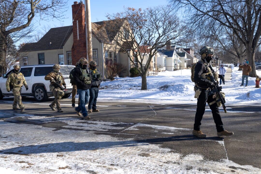 Federal immigration agents stand guard after one of their vehicles was involved in a crash while making an apprehension in St. Paul, Minn., on Jan. 31, 2026. (Scott Olson/Getty Images)