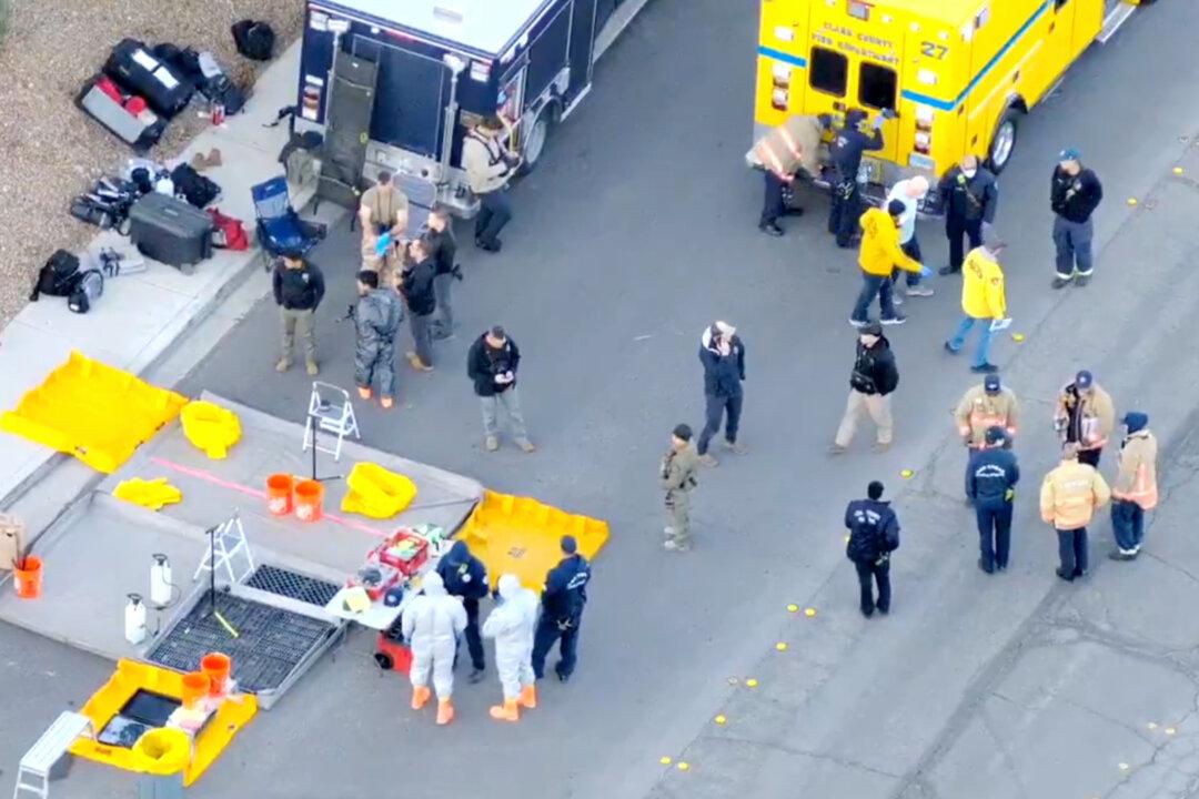In this image from a video, law enforcement officers search a house in Las Vegas on Jan. 31, 2026. (Las Vegas Metropolitan Police Department via AP)