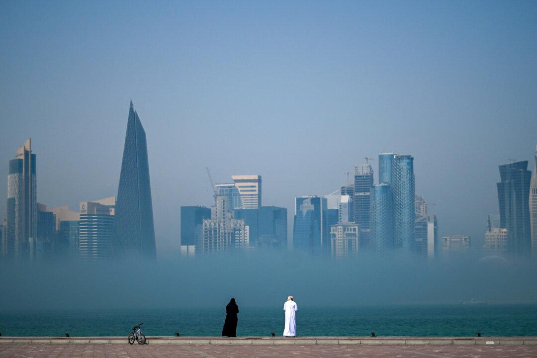 People look at the skyline covered in fog in Doha, Qatar, on Feb. 9, 2026. (Mahmud Hams/AFP via Getty Images)
