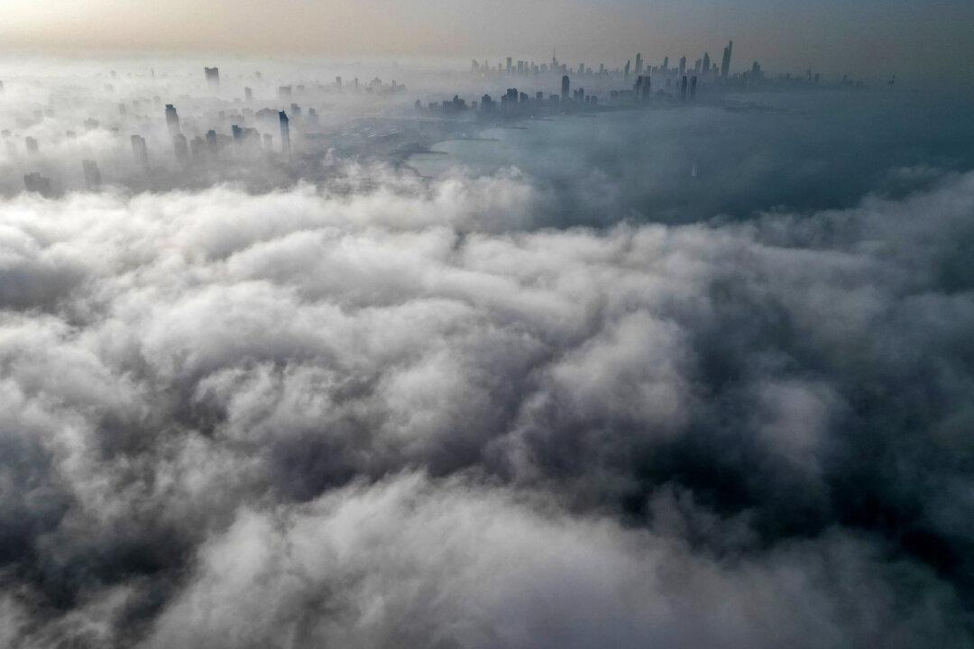 Buildings are seen through a veil of fog rolling over al-Salmeyya district in Kuwait City, on Feb. 9, 2026. (Yasser Al-Zayyat/AFP via Getty Images)