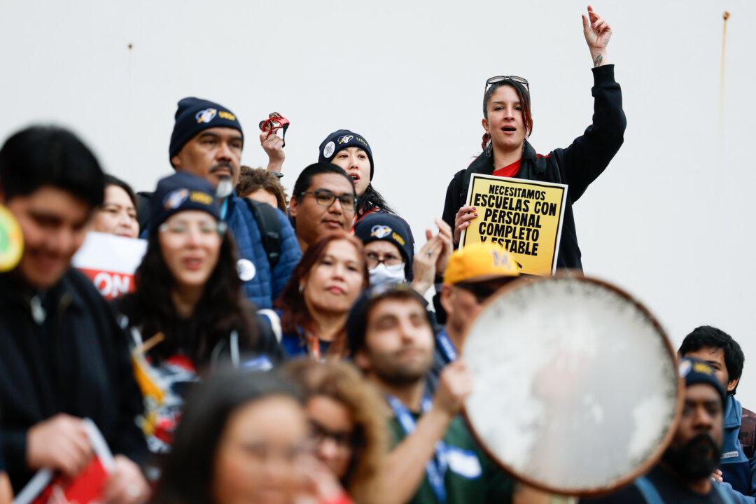 Teachers with the San Francisco Unified School District picket outside Mission High School on the first day of a citywide teachers' strike in San Francisco, on Feb. 9, 2026. Nearly 6,000 educators in the district walked off the job—the city’s first teachers’ strike in almost 50 years—after contract talks collapsed over wages, health benefits, and staffing, leaving all 120 district schools closed as negotiations continue. (Justin Sullivan/Getty Images)